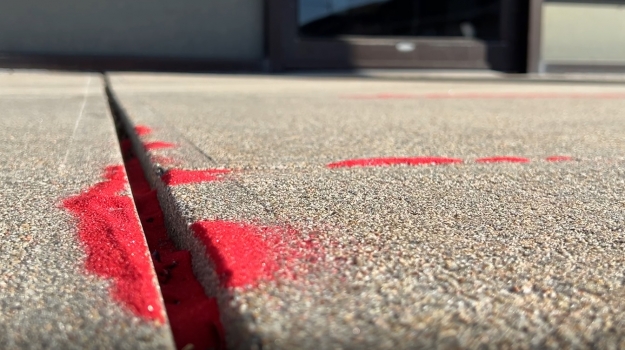 Red sand lined the sidewalk cracks in front of the Heartland United Way as a way to raise awareness of trafficking.